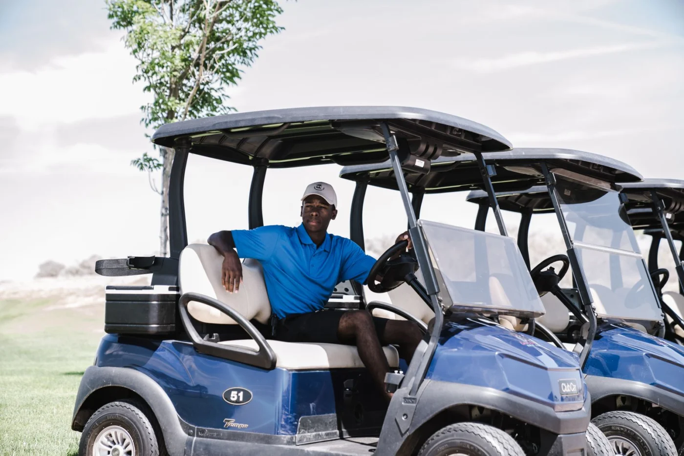 Golfer and buggy on the course
