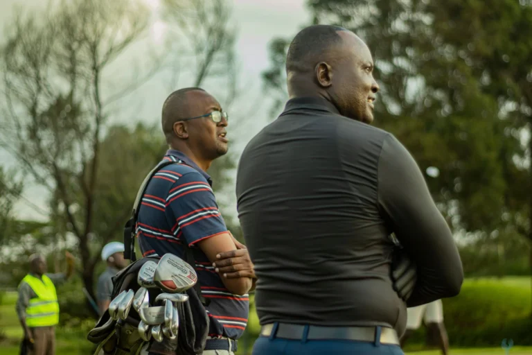 Two golfers walking a green fairway on a Nairobi golf course