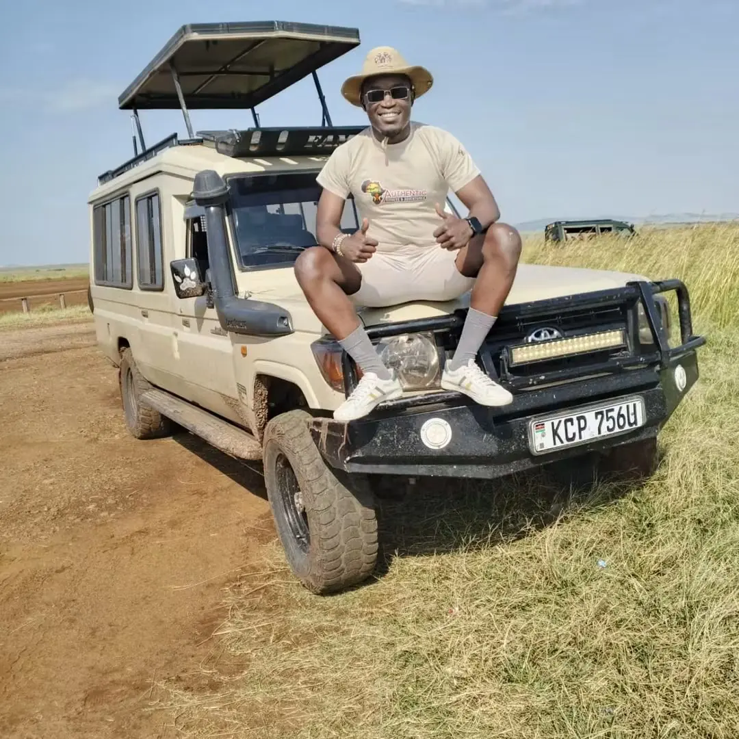 Guest standing by a safari Land Cruiser