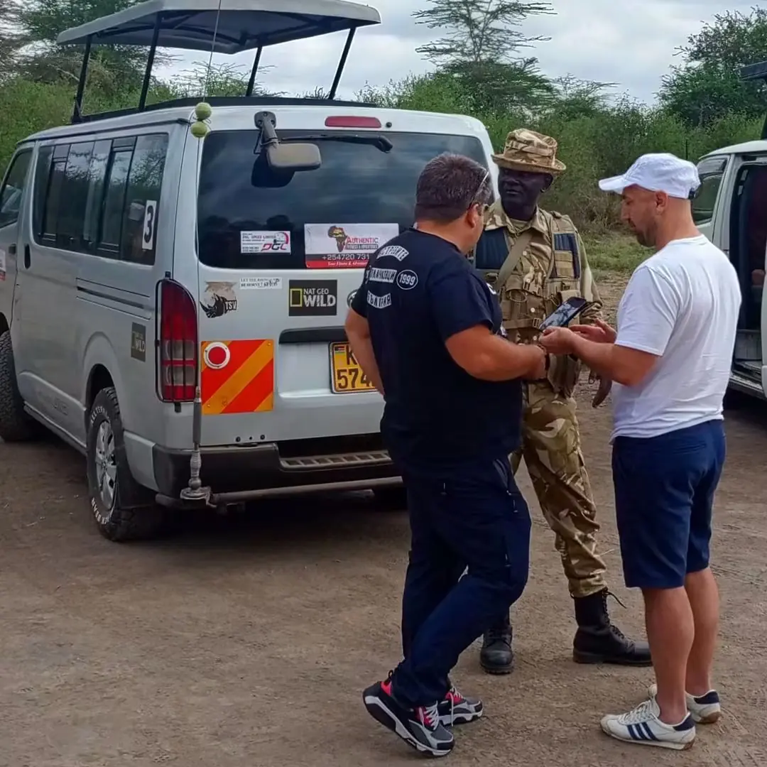 Guests with a ranger at a park gate